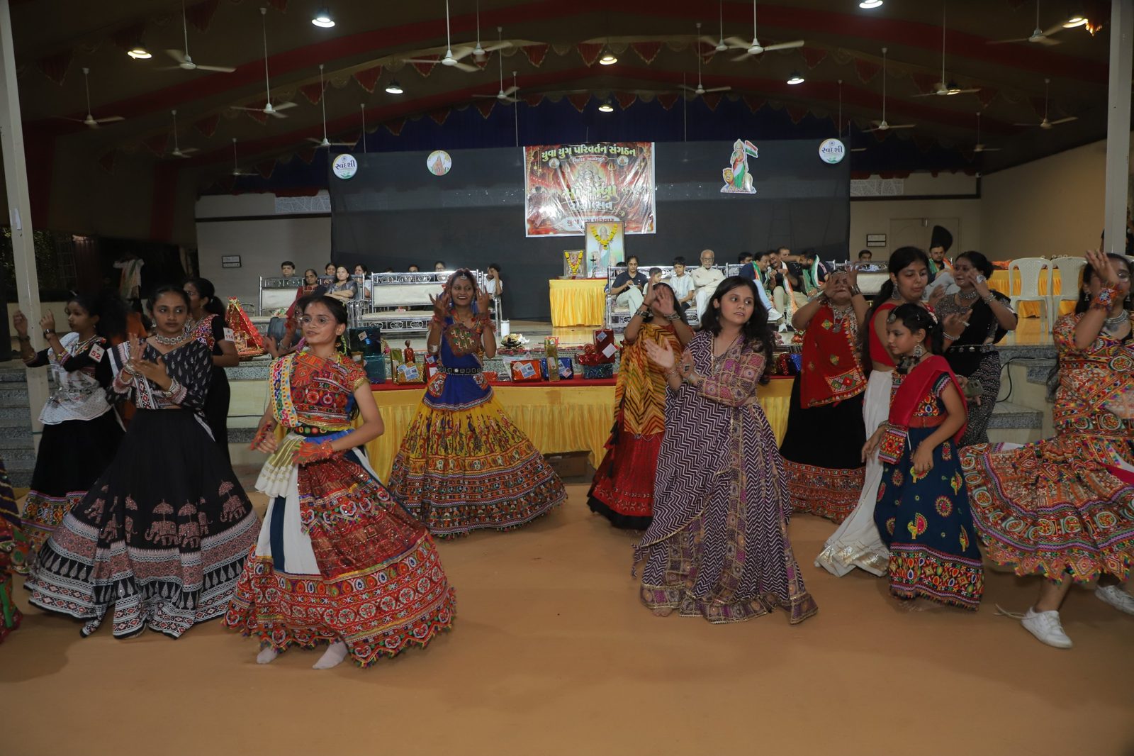 Girls and women dancing garba in front of the stage