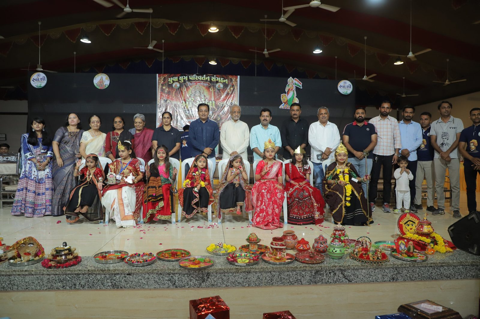 Girls dressed as Devi with guests and Y.Y.P members on stage