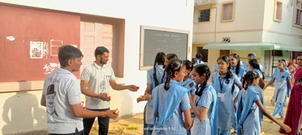 Y.Y.P members giving good-luck sweets to school students
