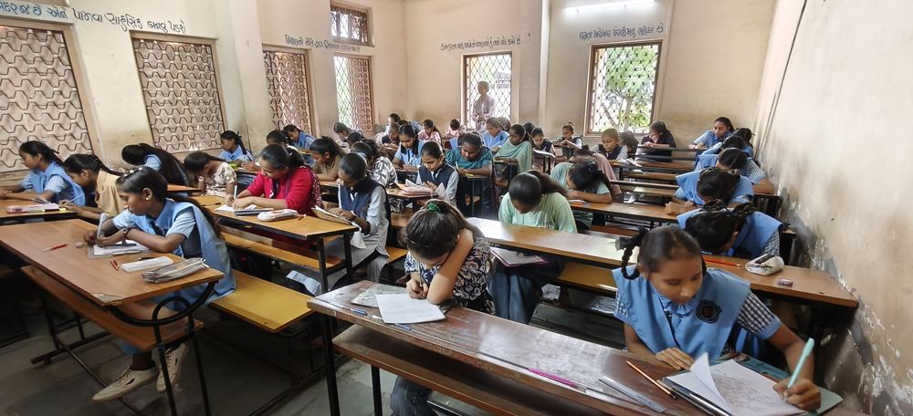 Students writing a cultural test in a classroom in Sihor