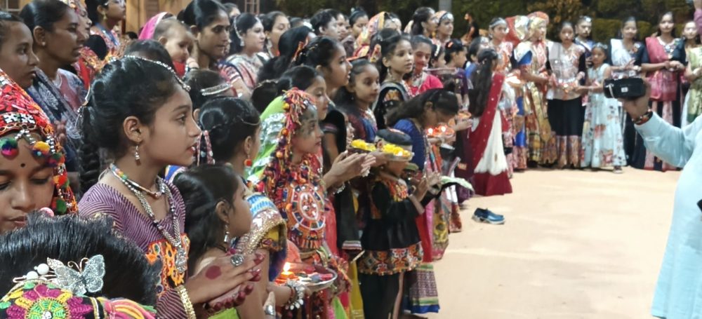 Girls in chaniya choli holding aarti thalis