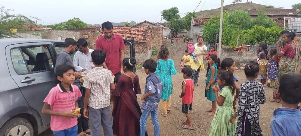 Snack distribution to children in a slum area on a birthday